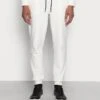 Calvin Klein COMFORT DEBOSSED LOGO SWEATPANTS - Jogginghose - Egret